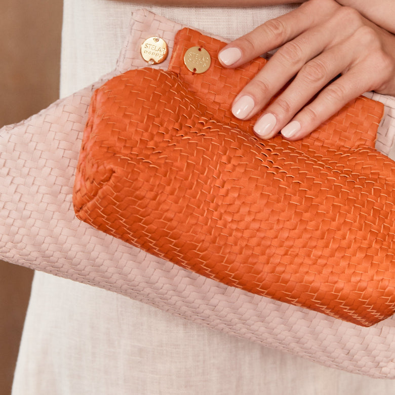 Small orange deals clutch bag